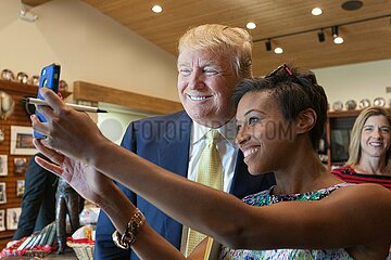 Jodi Whitworth poses with U.S. Republican presidential candidate Donald Trump during a campaign event at the museum and birthplace of actor John Wayne.