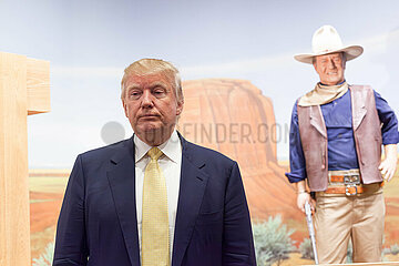 U.S. Republican presidential candidate Donald Trump poses with supporters as he tours the museum and birthplace of actor John Wayne