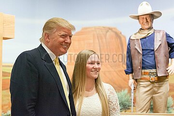 U.S. Republican presidential candidate Donald Trump poses with supporters as he tours the museum and birthplace of actor John Wayne