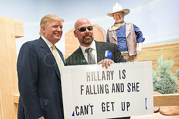 U.S. Republican presidential candidate Donald Trump poses with supporters as he tours the museum and birthplace of actor John Wayne