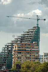 Albanien  Tirana - Hochhaus im Bau (Buerohaus  zur Zeit der Aufnahme pausiert) im Zentrum  vorne ein Wohnhaus